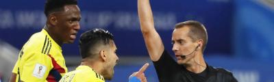 Mark Geiger gives Radamel Falcao (No. 9) of Colombia a yellow card during the World Cup match against England. 